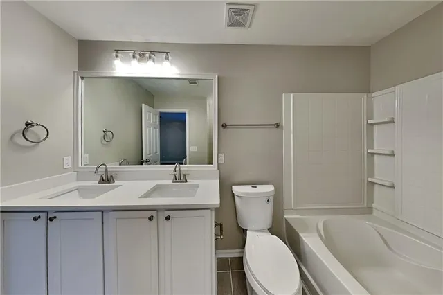 a bathroom with a sink toilet vanity and shower