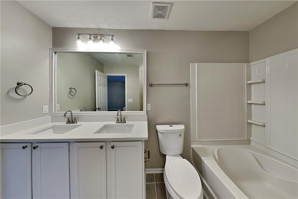 40 Parkmont Court Dallas, GA 30132 - Photo 9 of 19 a bathroom with a sink toilet vanity and shower