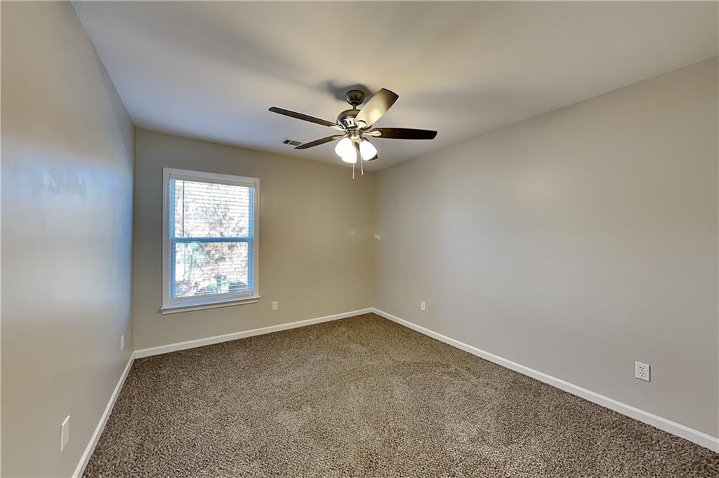 40 Parkmont Court Dallas, GA 30132 - Photo 10 of 19 an empty room with windows and chandelier fan