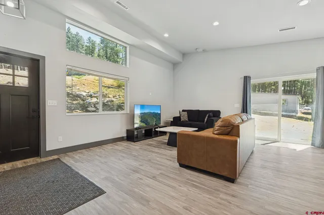 a living room with furniture and kitchen view