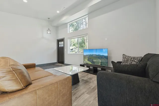 a kitchen with stainless steel appliances granite countertop a sink refrigerator and microwave