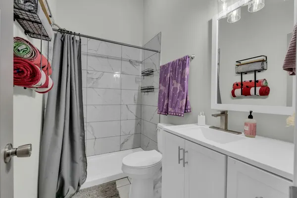 a bathroom with a sink toilet and shower