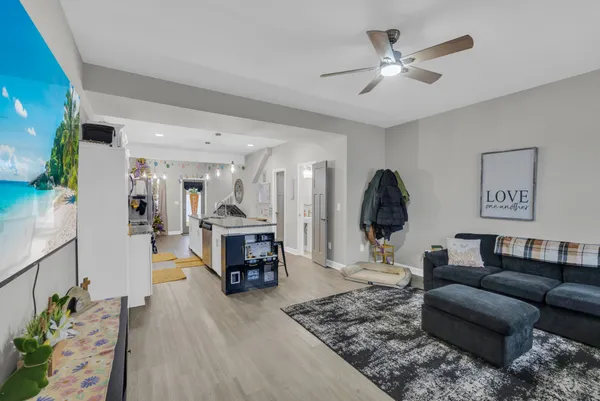 a living room with furniture and wooden floor