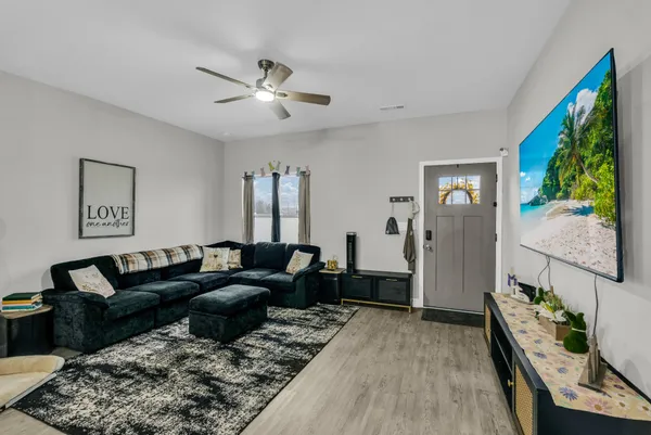 a living room with furniture and a flat screen tv