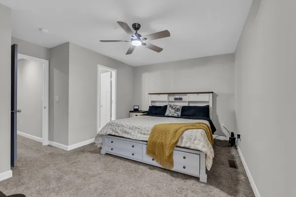 a bedroom with a bed and a chandelier
