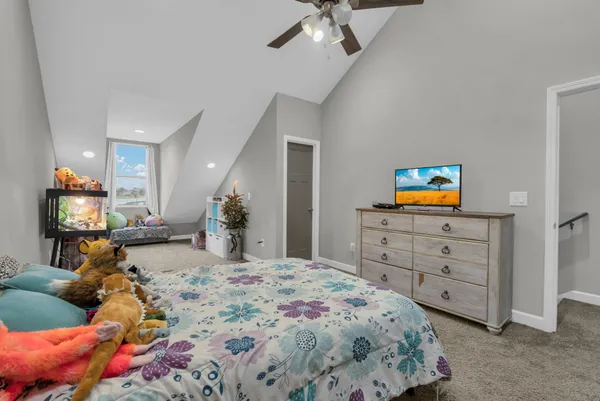 a bedroom with a bed and a television