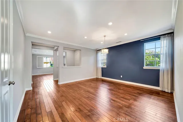 a view of a living room with hardwood floor and a flat screen tv