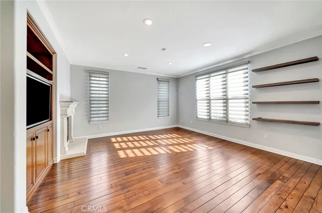 a large kitchen with stainless steel appliances granite countertop a lot of counter space and wooden floors