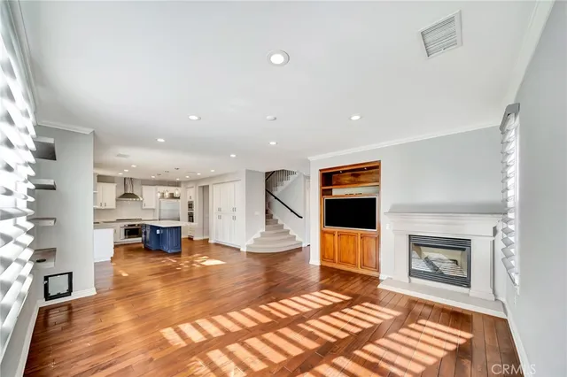a kitchen with stainless steel appliances a stove a sink a refrigerator and cabinets