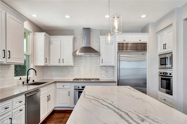 a view of empty room with wooden floor and fireplace