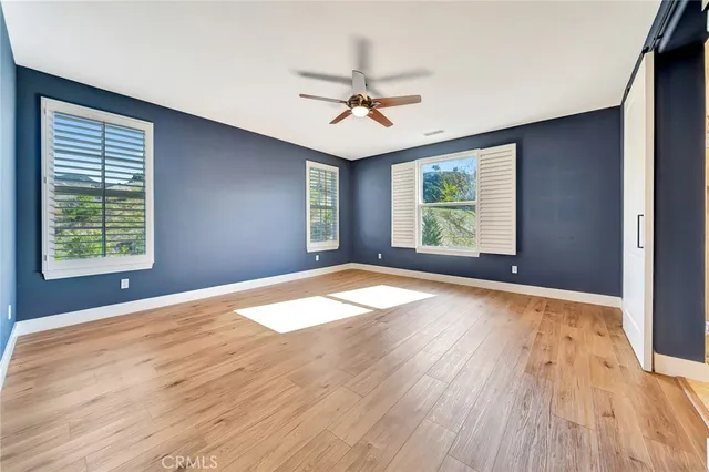 a view of a room with wooden floor and entryway