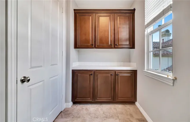 a view of a house with fountain plants and large tree
