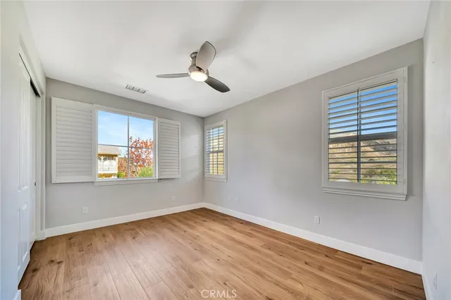 a view of a white house next to a yard