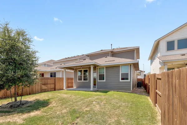 a view of a house with a backyard
