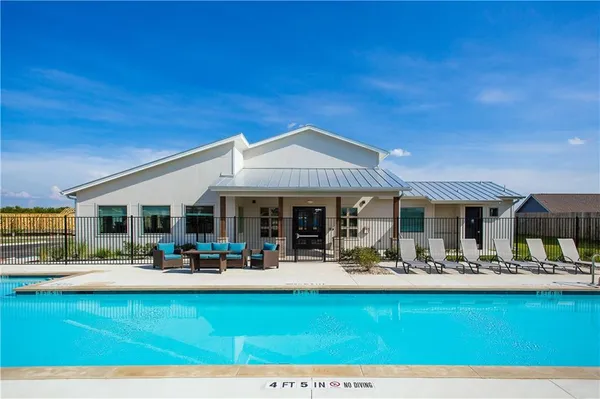 a view of a patio with swimming pool table and chairs