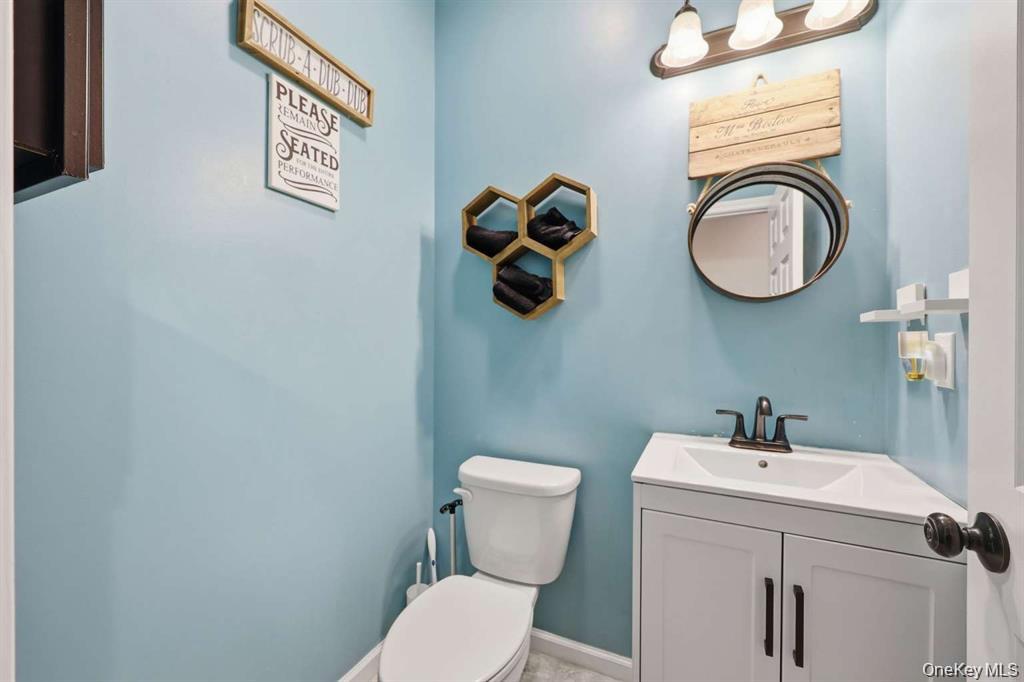 133 Old Chester Road Goshen, NY 10924 - Photo 13 of 33 a bathroom with a toilet a sink and mirror