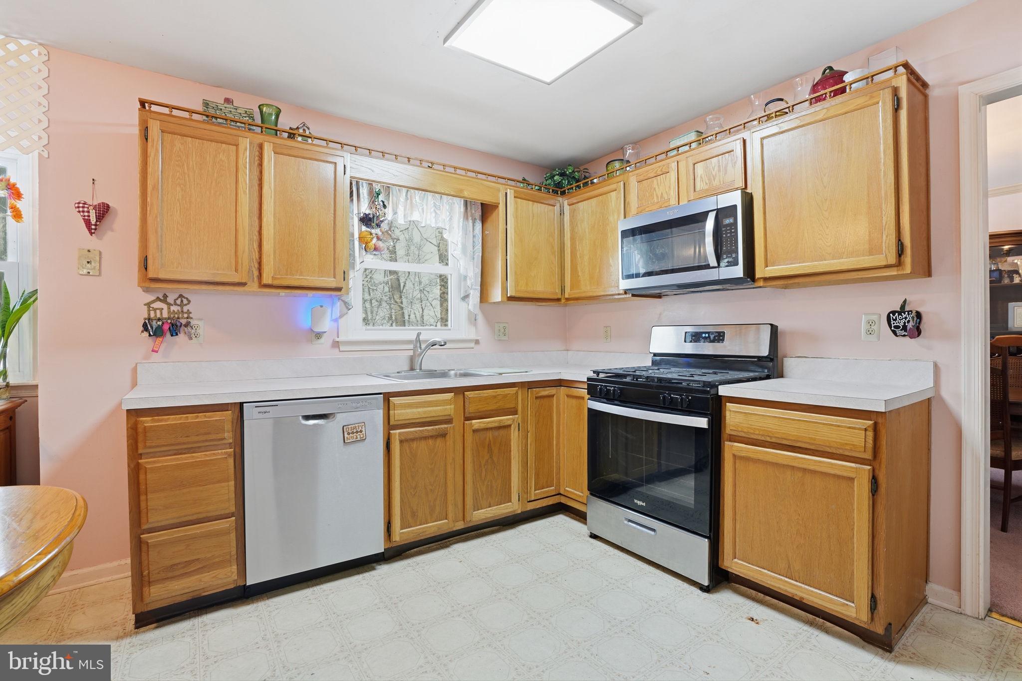 937 High Pointe Circle Langhorne, PA 19047 - Photo 11 of 47 a kitchen with stainless steel appliances granite countertop a sink stove and microwave
