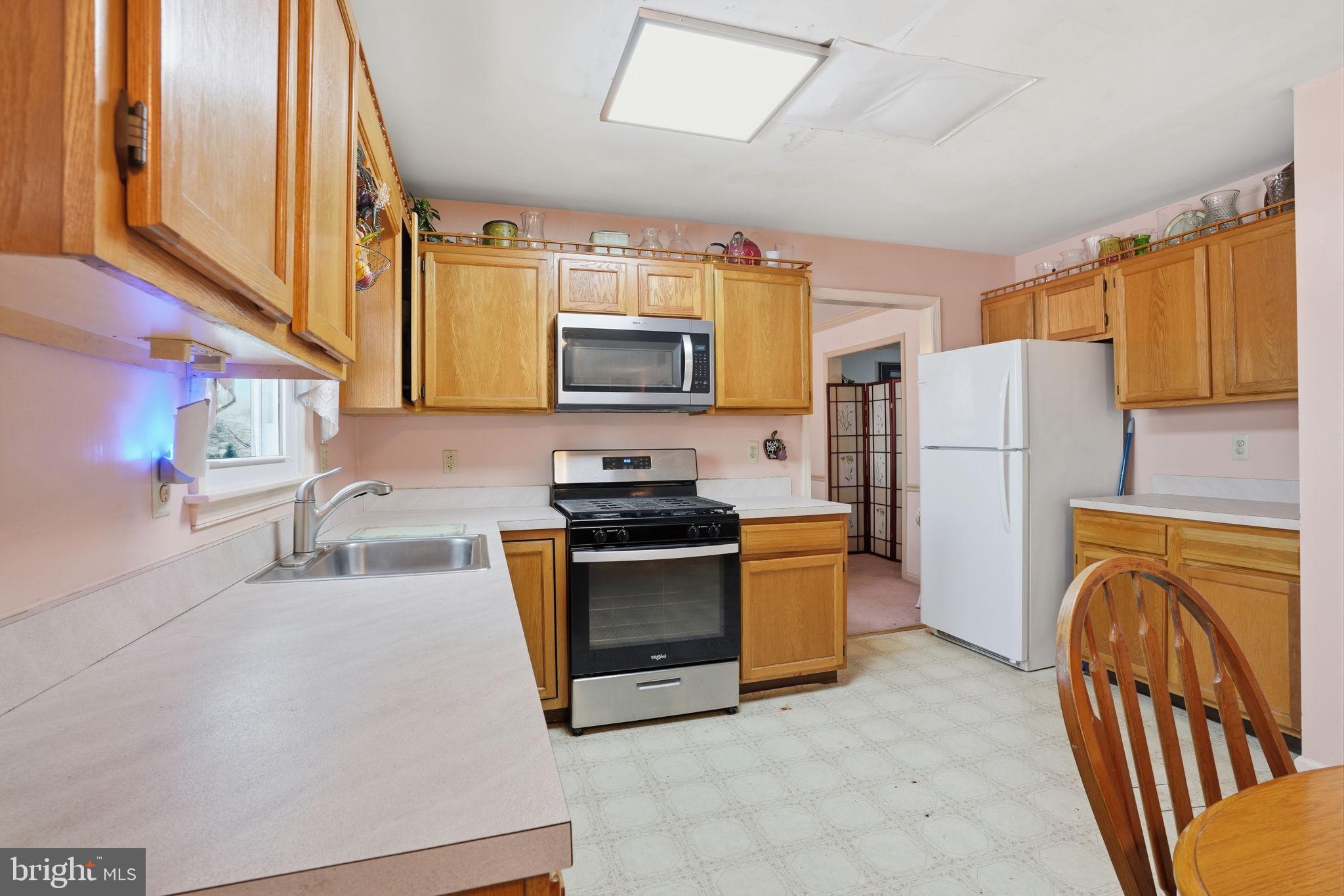 937 High Pointe Circle Langhorne, PA 19047 - Photo 14 of 47 a kitchen with stainless steel appliances granite countertop a refrigerator a stove top oven a sink and dishwasher