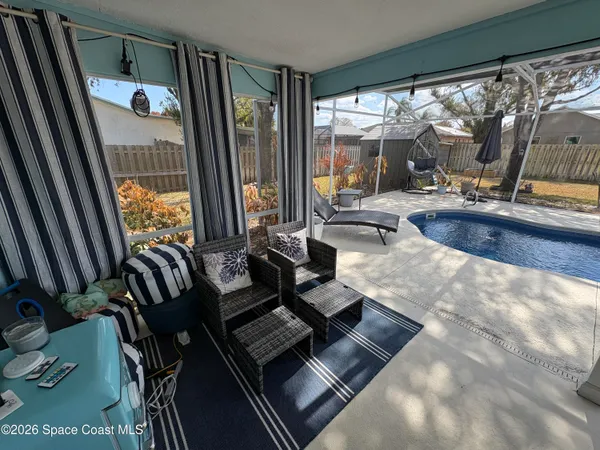 a room with furniture and large windows