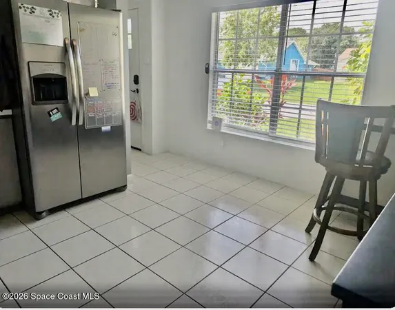 a view of a livingroom with furniture and a window