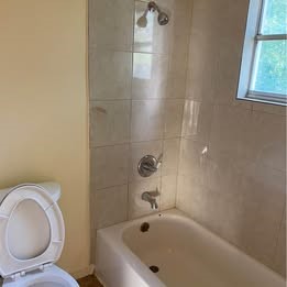 6406 Schiller Street Houston, TX 77055 - Photo 3 of 10 a bathroom with a toilet and a bathtub