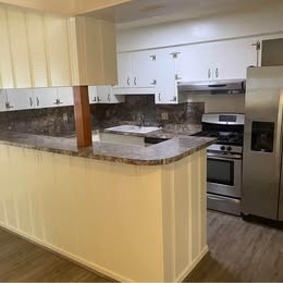6406 Schiller Street Houston, TX 77055 - Photo 7 of 10 a kitchen with stainless steel appliances granite countertop a stove a sink and a refrigerator