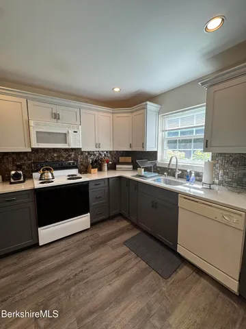 a kitchen with granite countertop a stove and cabinets