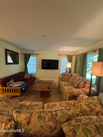 a bed room with a bed window and a chair