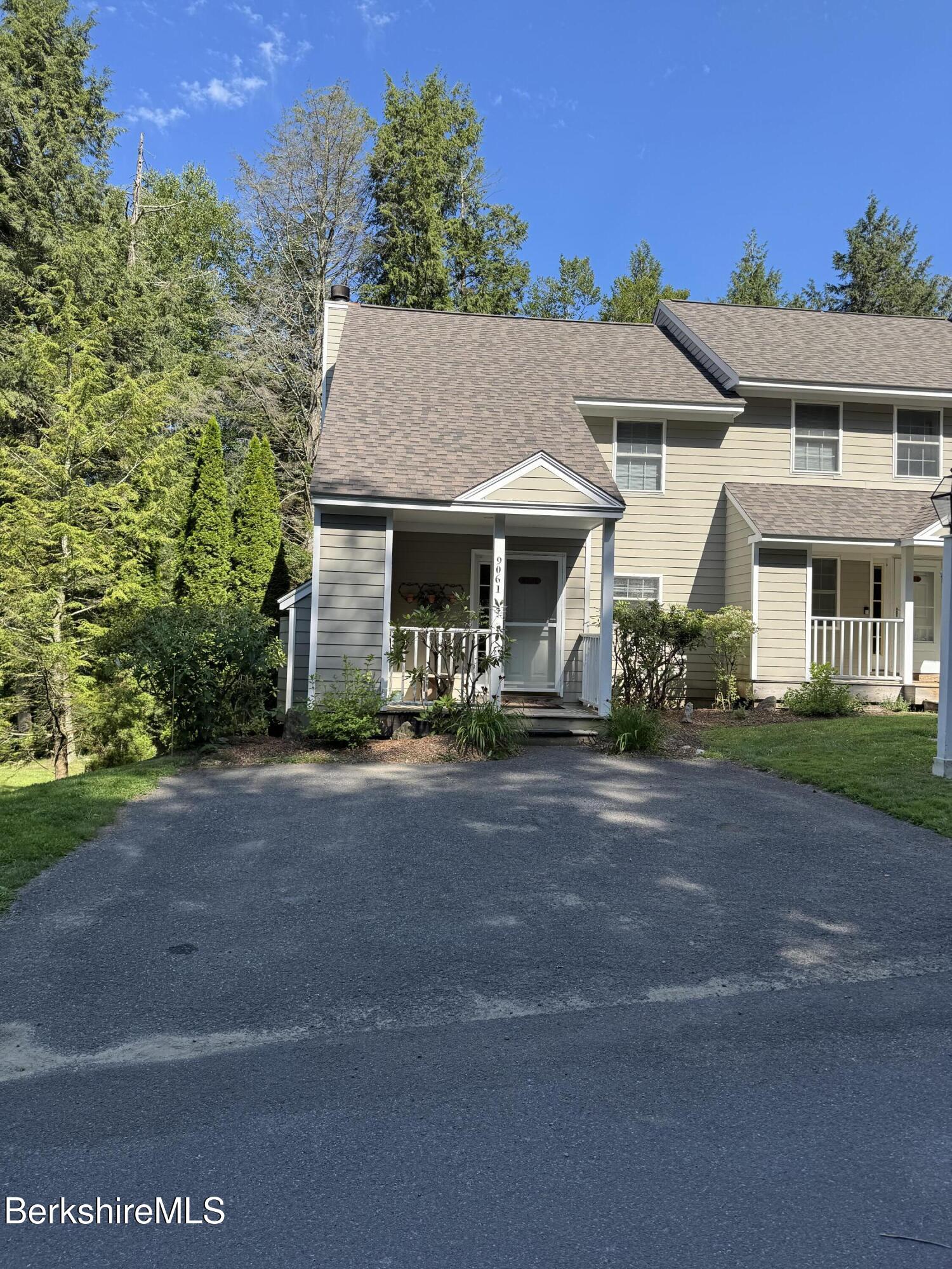 37 Corey Road, Unit 9061 Hancock, MA 01237 - Photo 2 of 30 a view of a white house with a yard plants and large tree