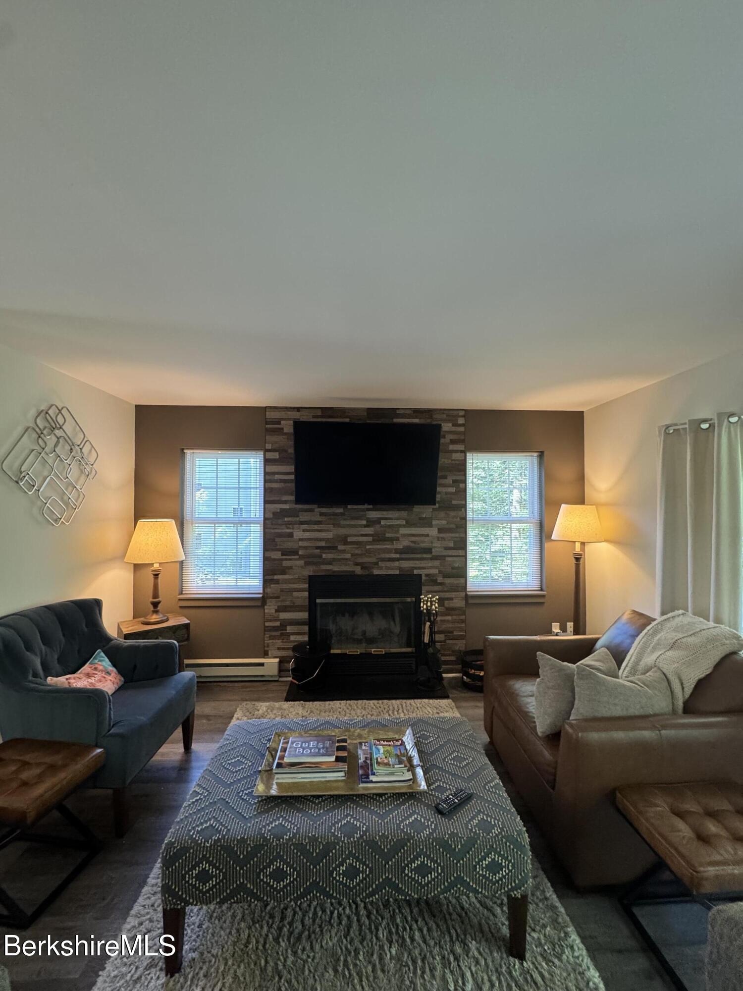 37 Corey Road, Unit 9061 Hancock, MA 01237 - Photo 22 of 30 a living room with furniture a rug a fireplace and a window