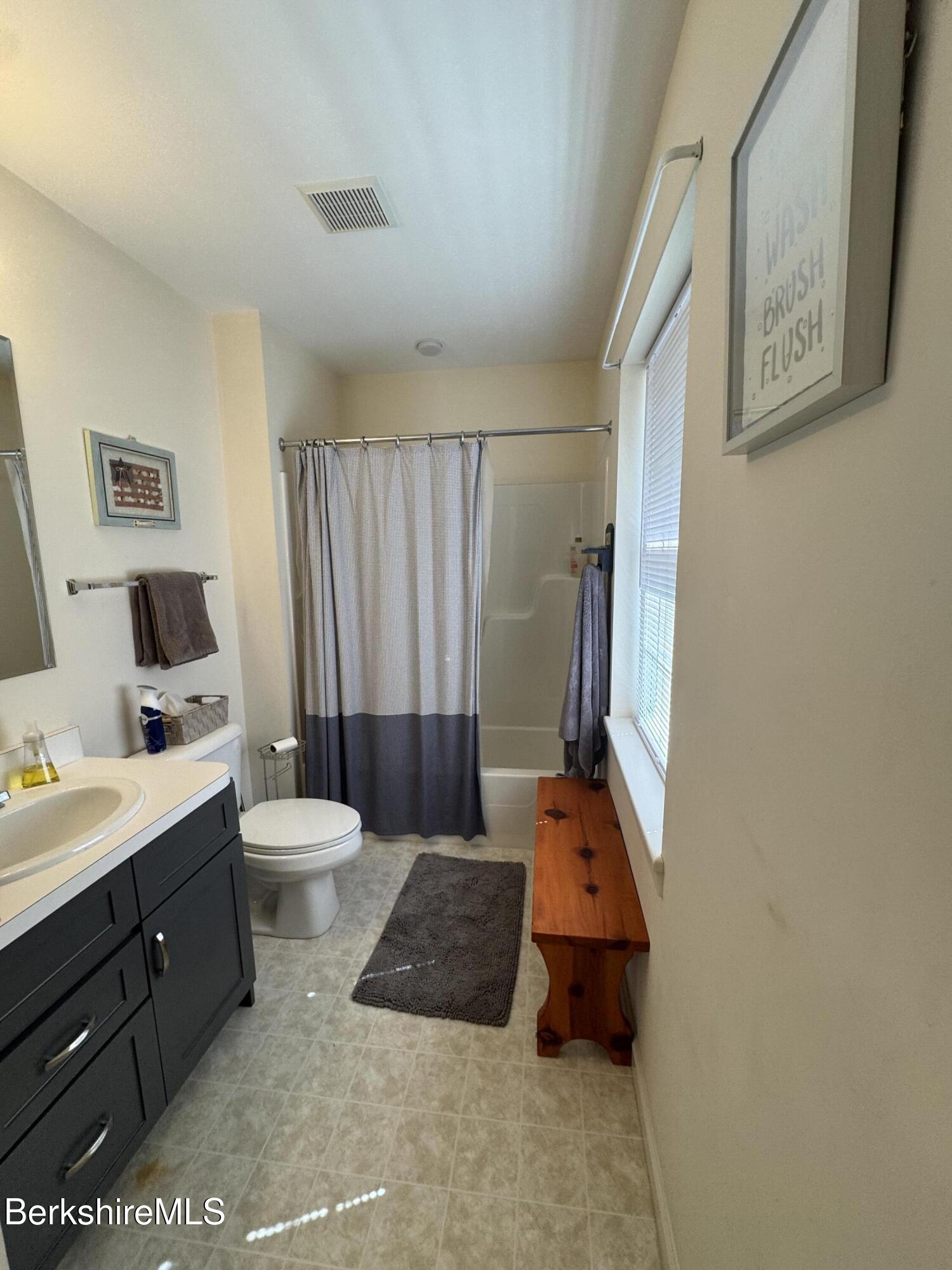 37 Corey Road, Unit 9061 Hancock, MA 01237 - Photo 25 of 30 a spacious bathroom with a double vanity sink and a mirror