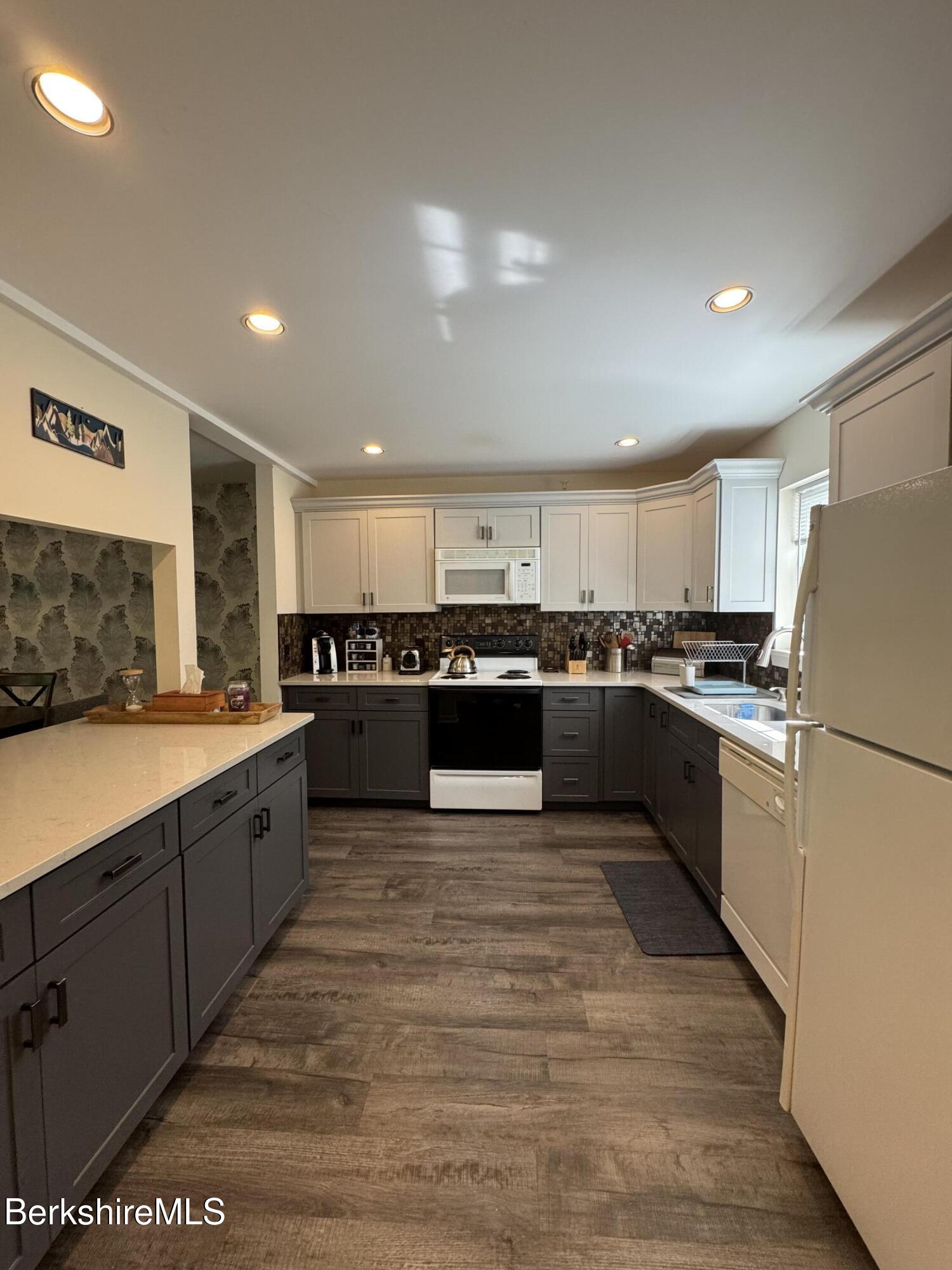 37 Corey Road, Unit 9061 Hancock, MA 01237 - Photo 10 of 30 a large kitchen with cabinets and stainless steel appliances
