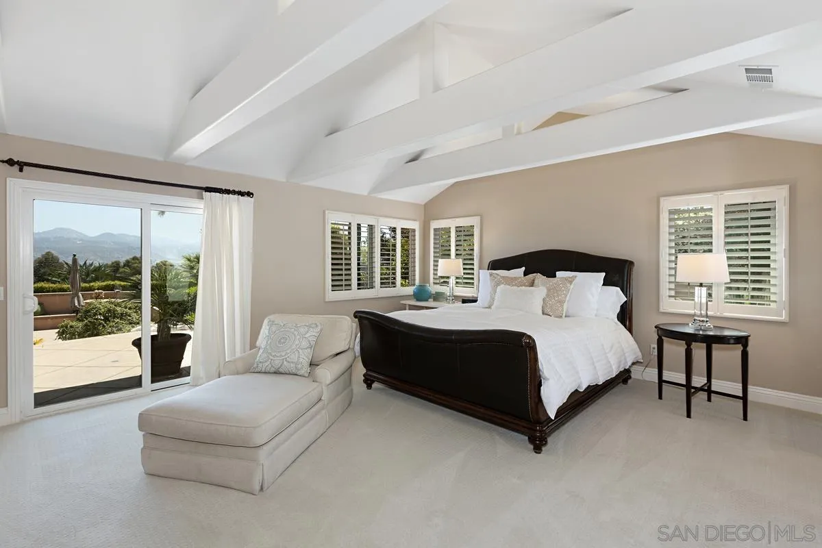 14258 Palisades Drive Poway, CA 92064 - Photo 14 of 40 a bed sitting in a spacious bedroom next to a large window