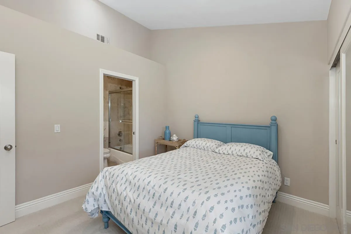 14258 Palisades Drive Poway, CA 92064 - Photo 20 of 40 a bed sitting in a bedroom next to a bathroom