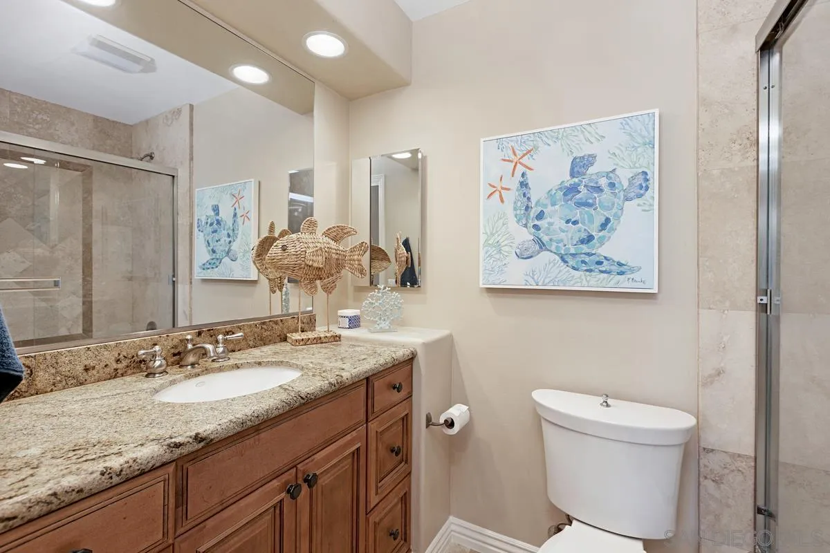 14258 Palisades Drive Poway, CA 92064 - Photo 21 of 40 a bathroom with a granite countertop sink a toilet and a mirror