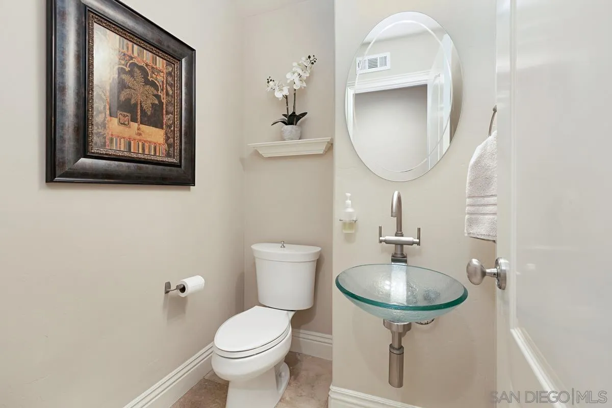 14258 Palisades Drive Poway, CA 92064 - Photo 26 of 40 a bathroom with a toilet a sink and a mirror