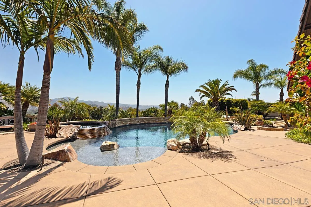 14258 Palisades Drive Poway, CA 92064 - Photo 29 of 40 a view of a swimming pool with a table and chairs