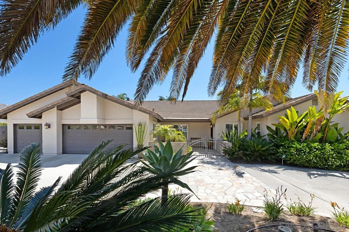 14258 Palisades Drive Poway, CA 92064 - Photo 3 of 40 a view of a white house with a yard and potted plants