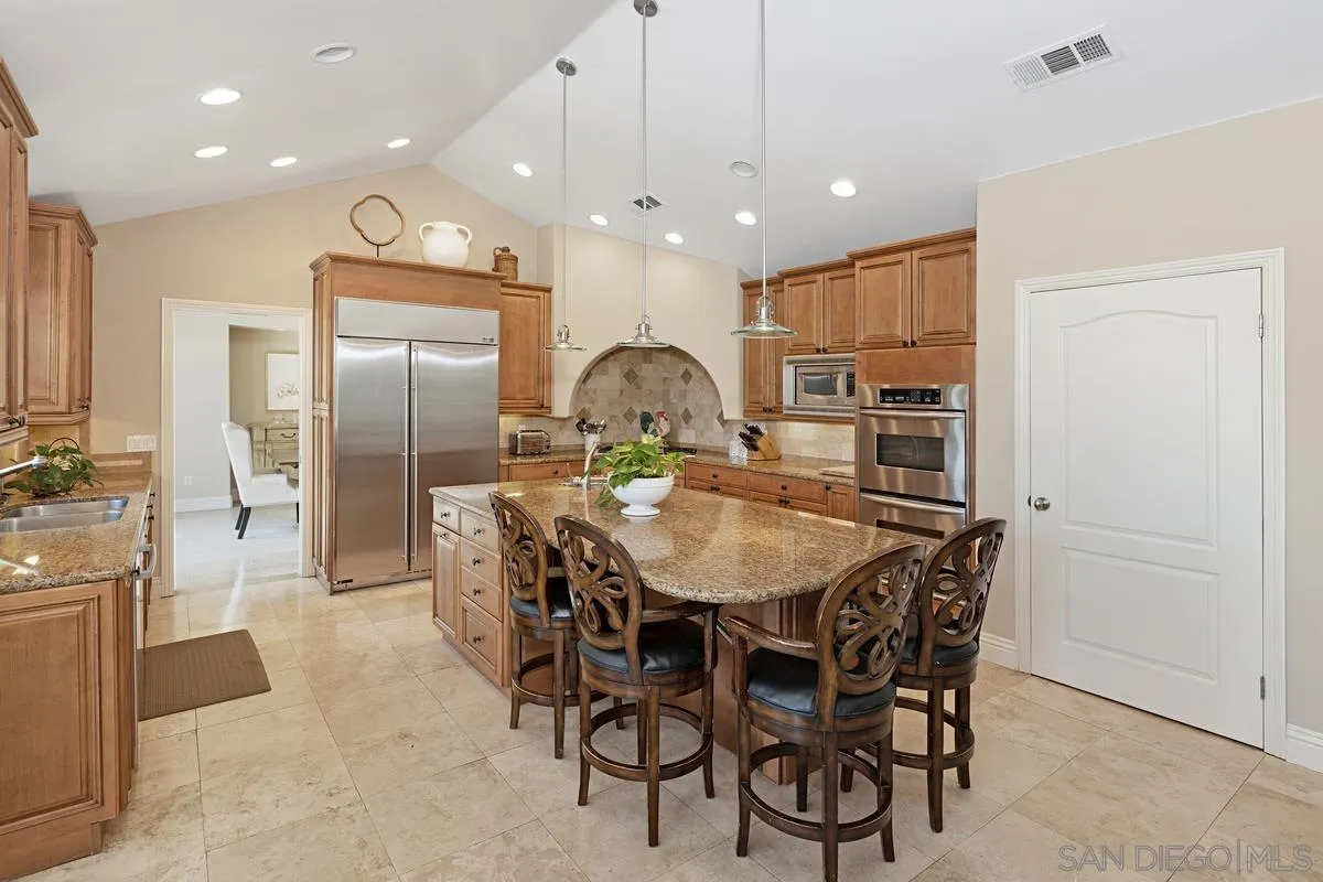 14258 Palisades Drive Poway, CA 92064 - Photo 8 of 40 a large kitchen with a table and chairs