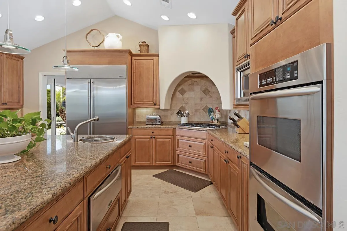 14258 Palisades Drive Poway, CA 92064 - Photo 10 of 40 a kitchen with stainless steel appliances granite countertop a sink and cabinets