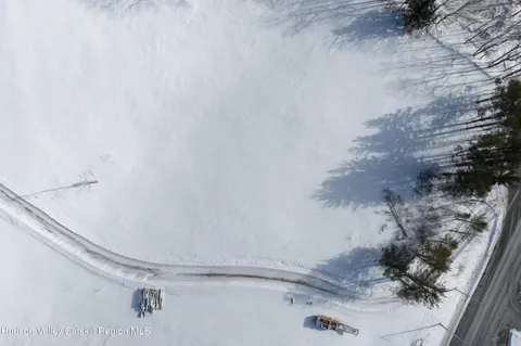 a view of white house with a snow on the road