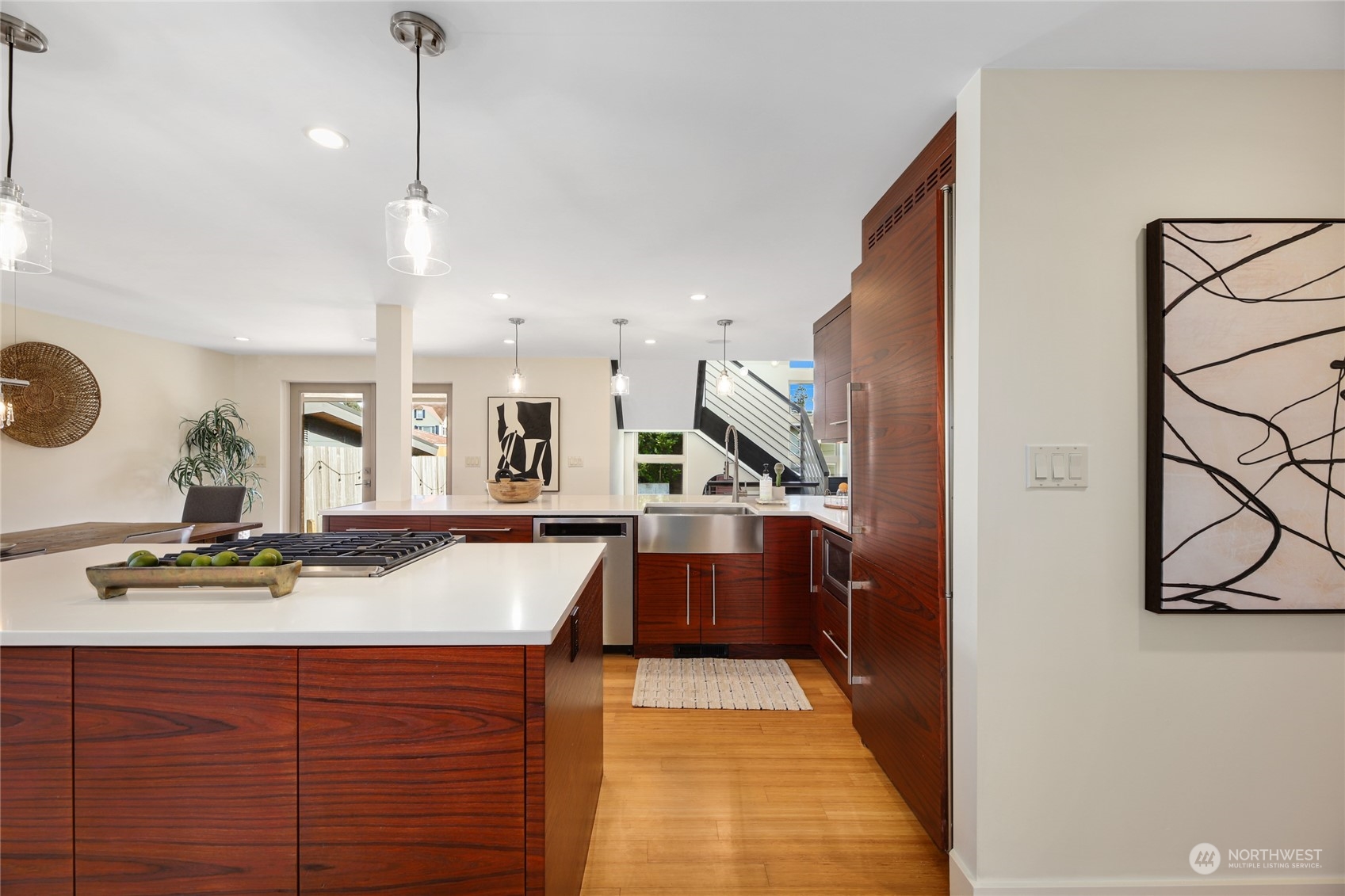 2148 Sunset Avenue Southwest Seattle, WA 98116 - Photo 12 of 40 a room with kitchen island stainless steel appliances sink stove and wooden floor