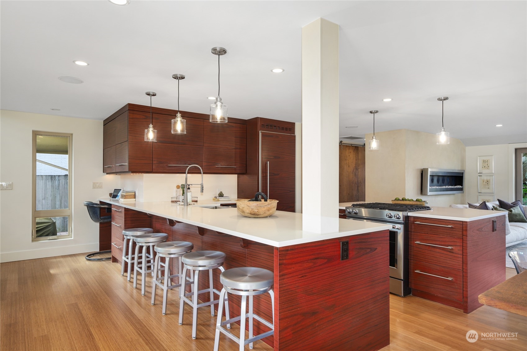 2148 Sunset Avenue Southwest Seattle, WA 98116 - Photo 13 of 40 a kitchen with stainless steel appliances kitchen island a table and chairs in it