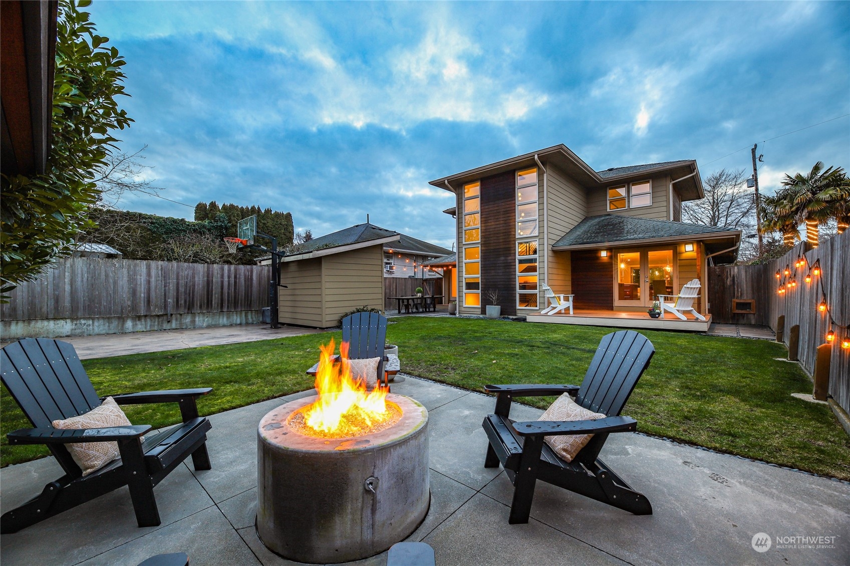2148 Sunset Avenue Southwest Seattle, WA 98116 - Photo 2 of 40 a backyard of a house with table and chairs