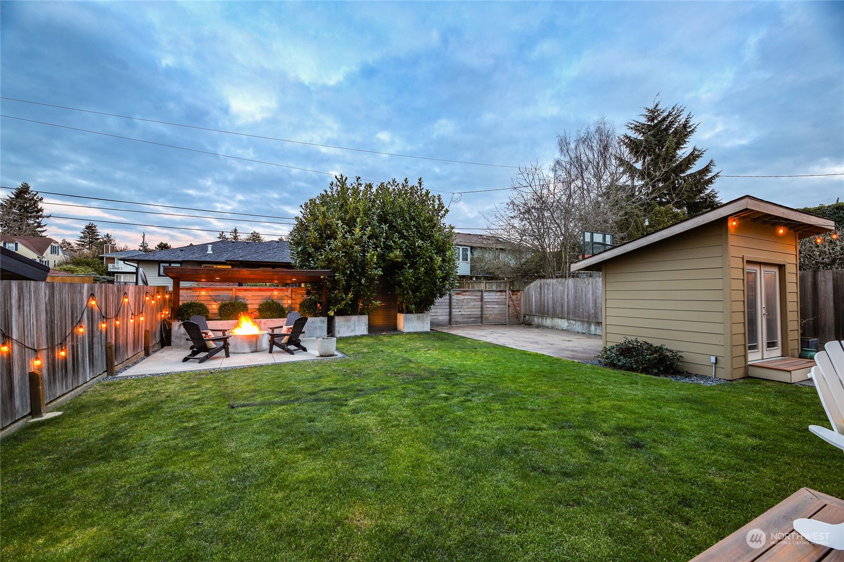 2148 Sunset Avenue Southwest Seattle, WA 98116 - Photo 35 of 40 a view of a backyard with table and chairs and a garage
