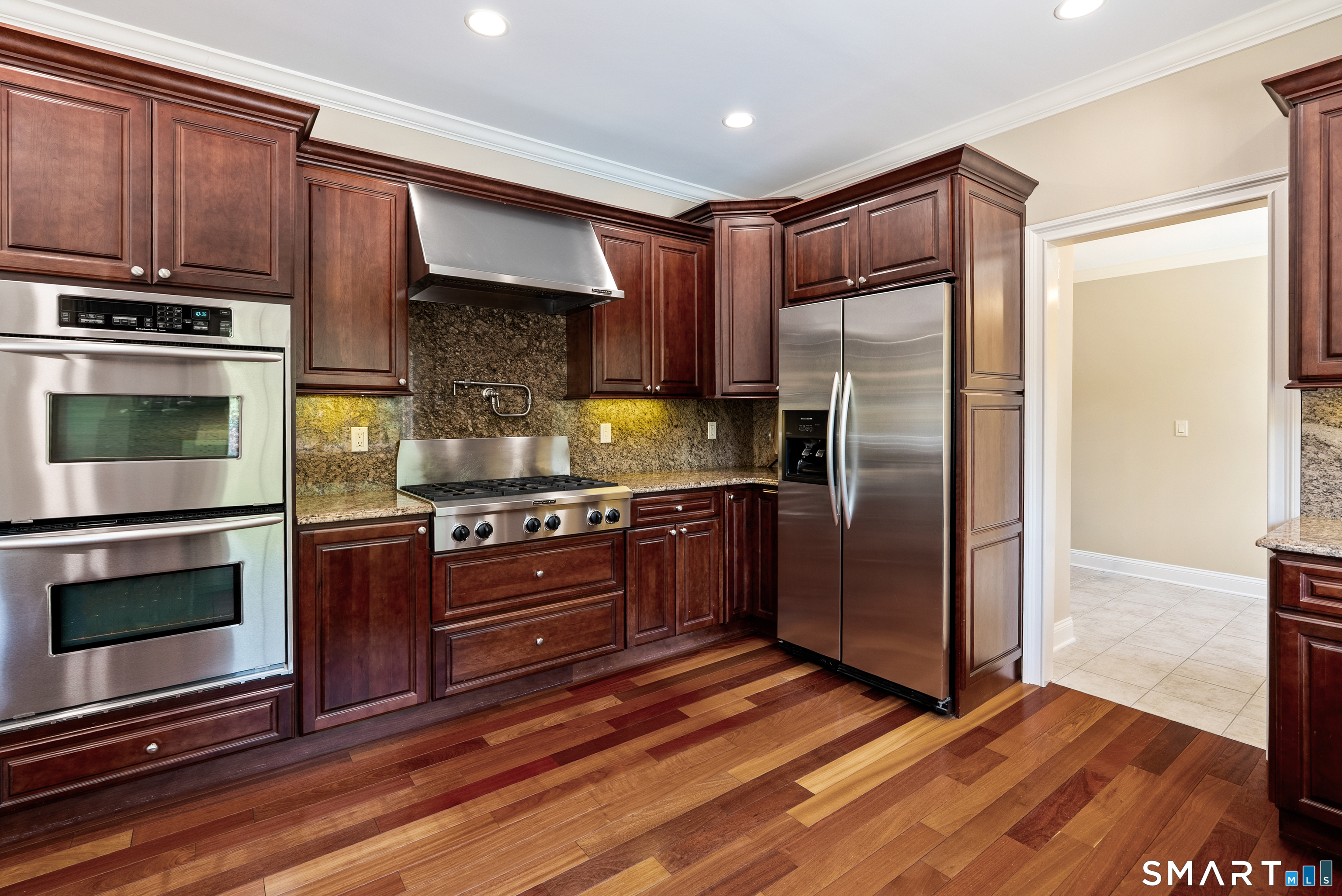 46 Andrews Road Wolcott, CT 06716 - Photo 20 of 40 a kitchen with granite countertop wooden cabinets a stainless steel appliances and a counter space