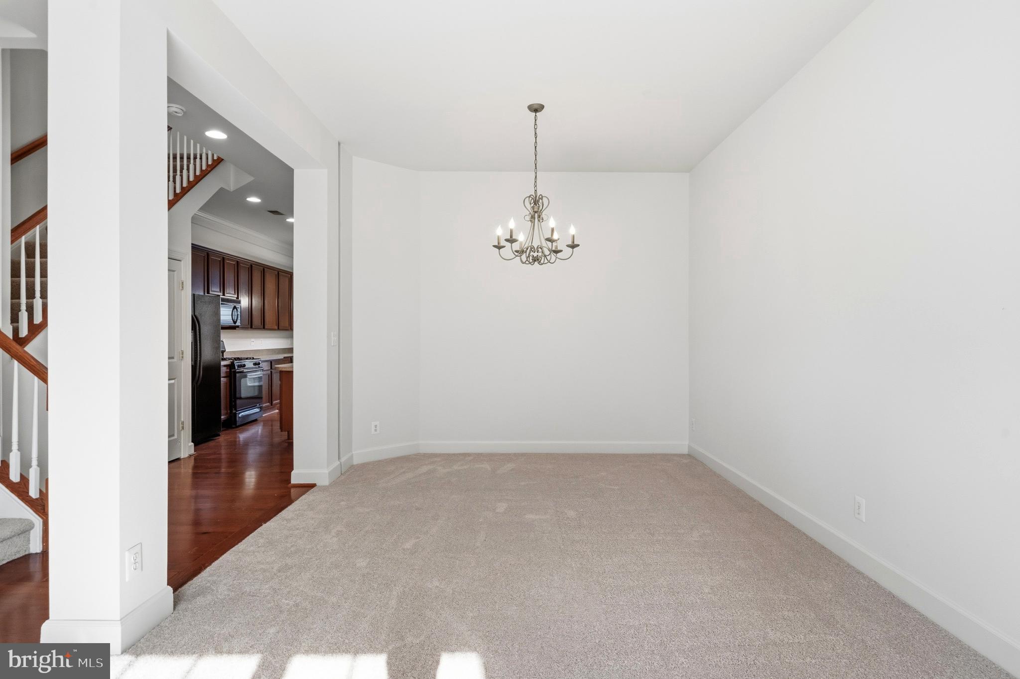 9227 Ribbon Falls Loop Bristow, VA 20136 - Photo 13 of 53 en empty room with chandelier