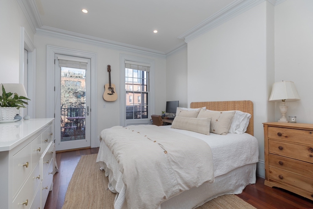 83 Montgomery Street, Unit 2 Boston, MA 02116 - Photo 4 of 11 a bedroom with a bed and a dresser