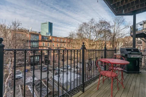 a view of a balcony with chairs