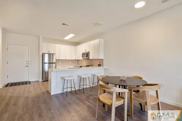 a kitchen with a table chairs stove and cabinets